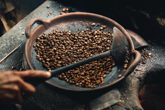 Coffee beans roasting in a wok